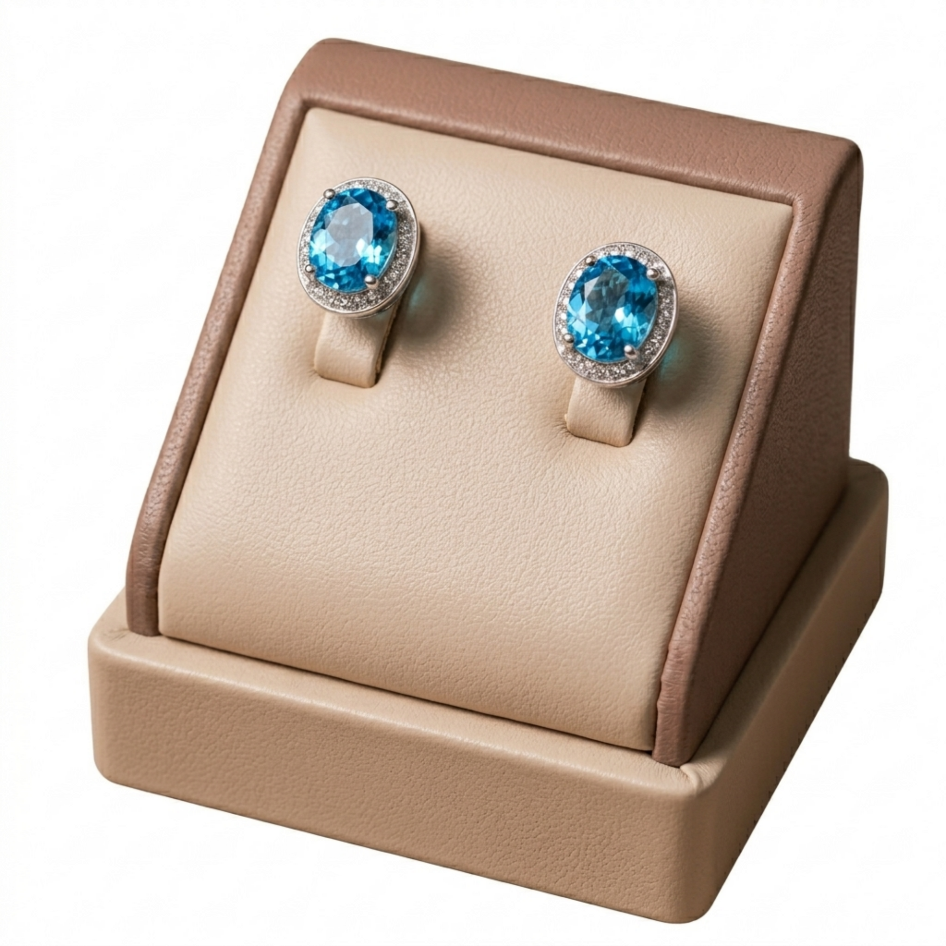 Round blue gemstone stud earrings with CZ halo in silver-tone, displayed on stand