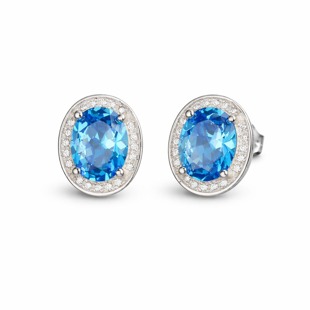 Round blue gemstone stud earrings with CZ halo settings in silver-tone metal