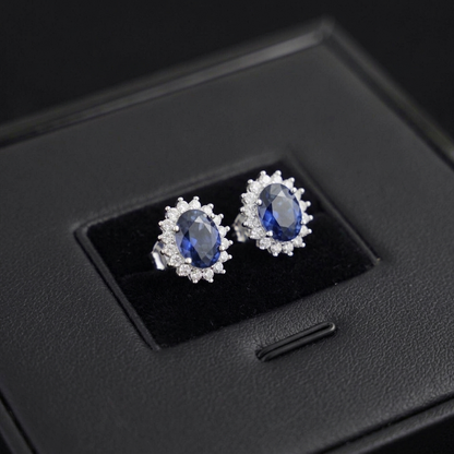 Oval sapphire cluster stud earrings with crystal halo, silver-tone setting
