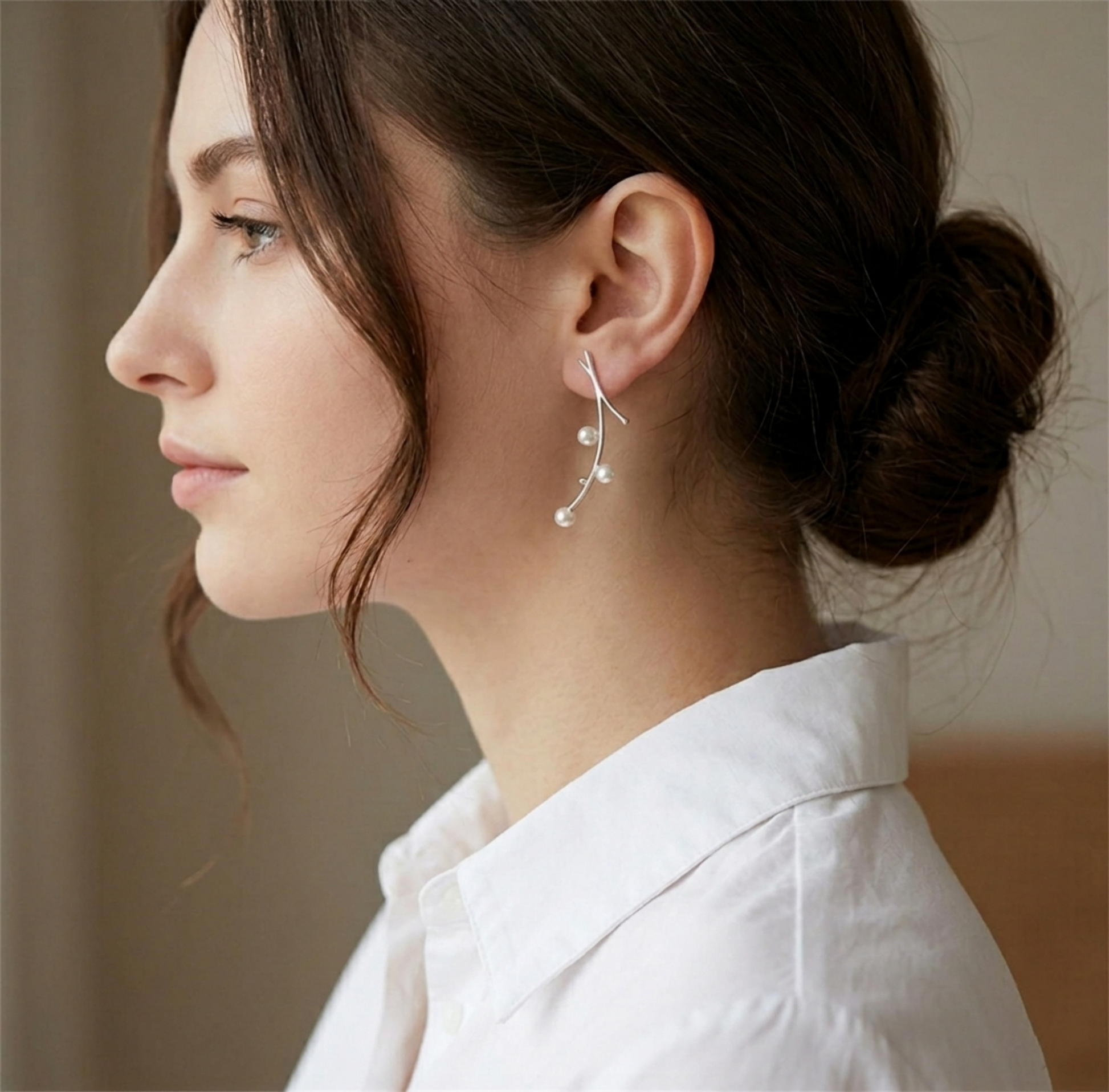 Pearl drop earrings with three white pearls on slender silver wires