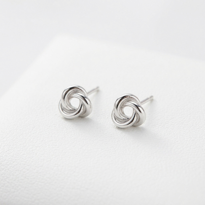 Silver knot stud earrings pair, circular trinity swirl front view