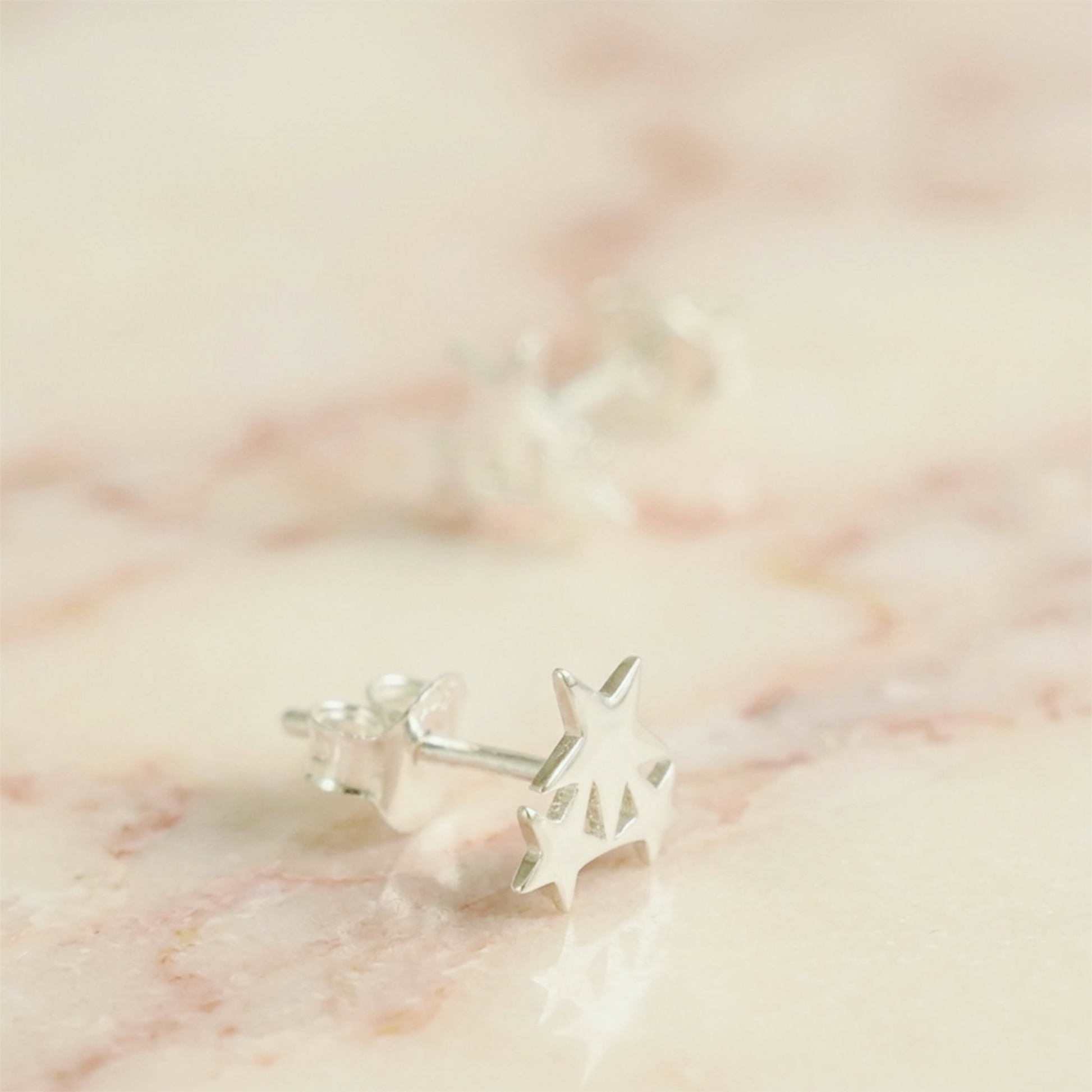Silver triple star stud earrings, single pair close-up