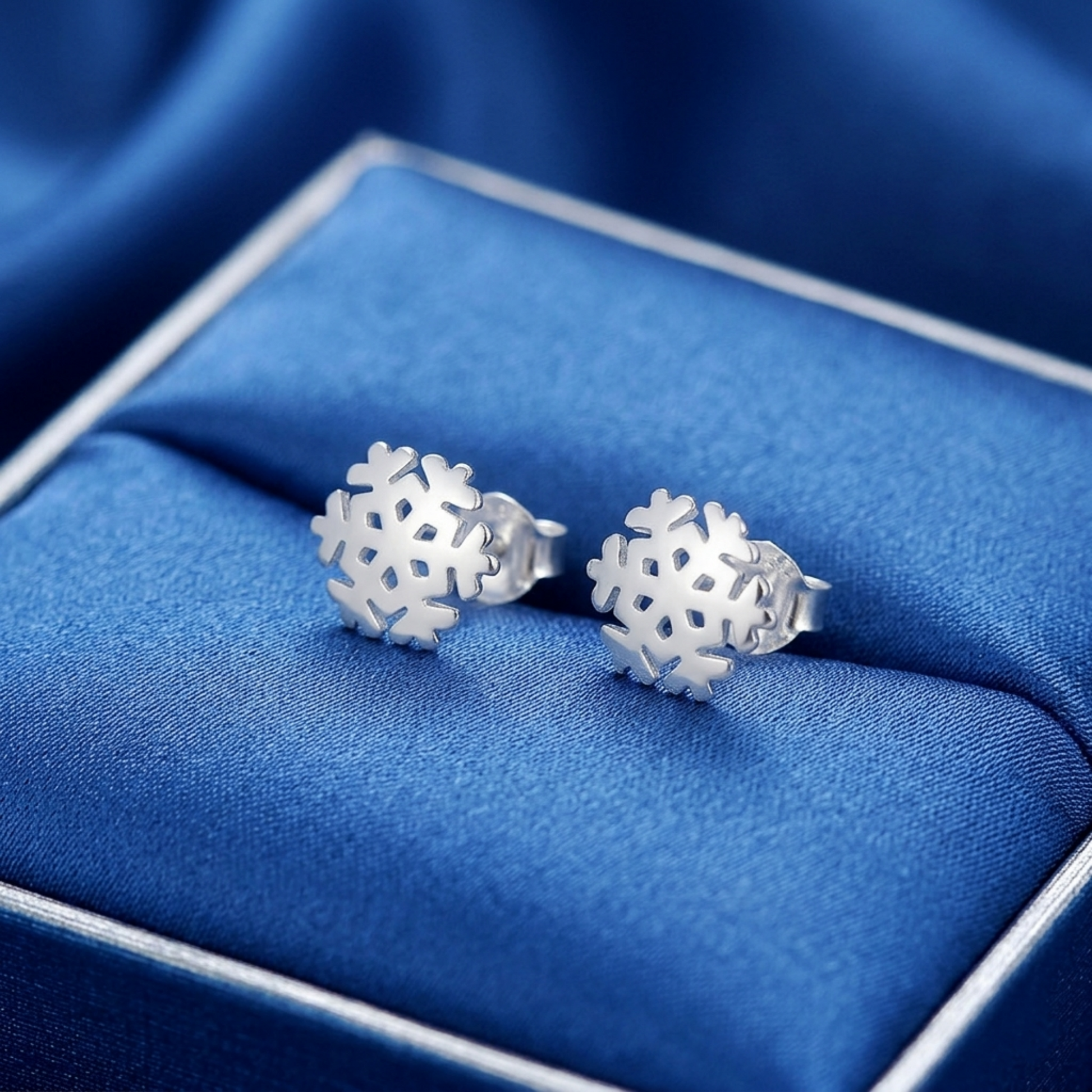 Pair of silver snowflake stud earrings in a gift box