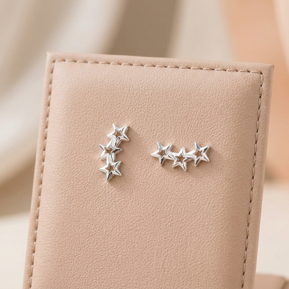 Silver-tone hollow star stud earring with four-star cluster