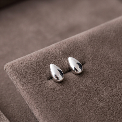 Polished rhodium teardrop stud earrings, reflective oval drop shape