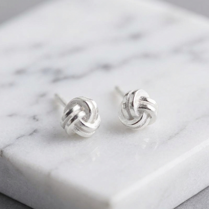 Mini love knot stud earrings, small round twisted knot motif, silver-tone