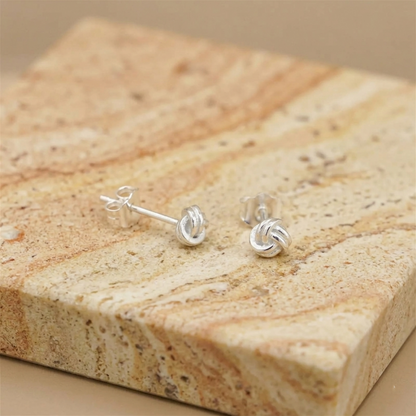 Mini love knot stud earrings with post and clasp, silver-tone twisted knot