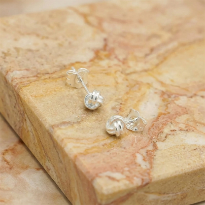 Mini love knot stud earrings, small twisted loop knot, silver-tone