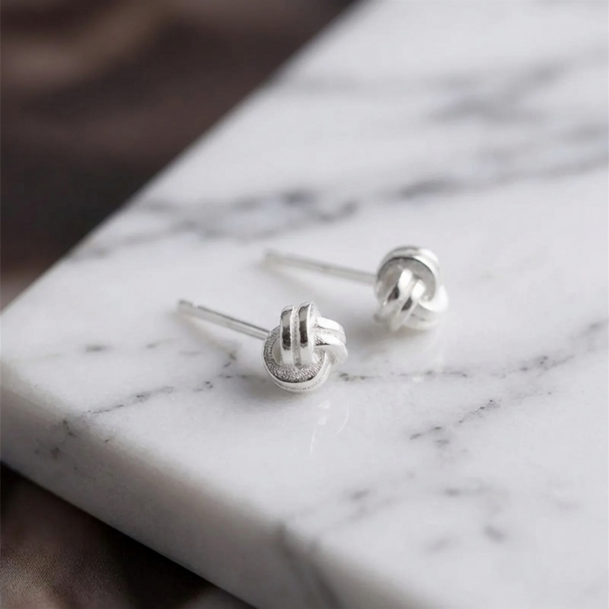 Mini love knot stud earrings with butterfly backs, silver-tone twisted knot
