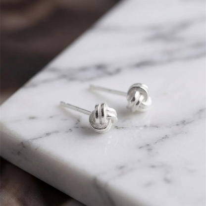 Mini love knot stud earrings with butterfly backs, silver-tone twisted knot
