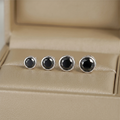 Bezel solitaire stud earrings, round black center stones in silver-tone bezels
