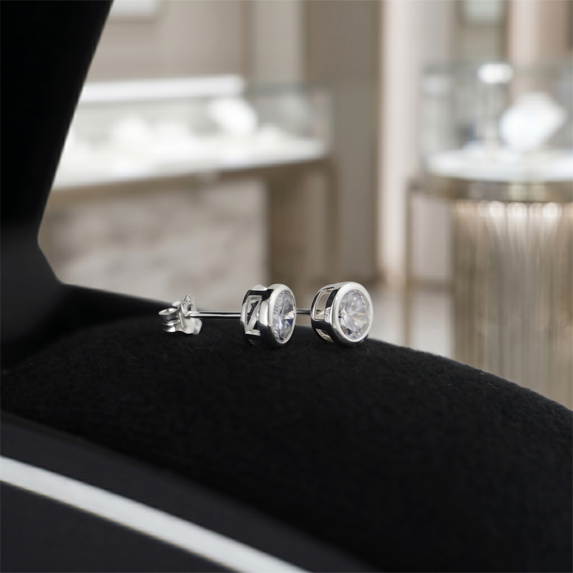 Bezel Solitaire Studs in clear, round bezel setting with polished metal backs