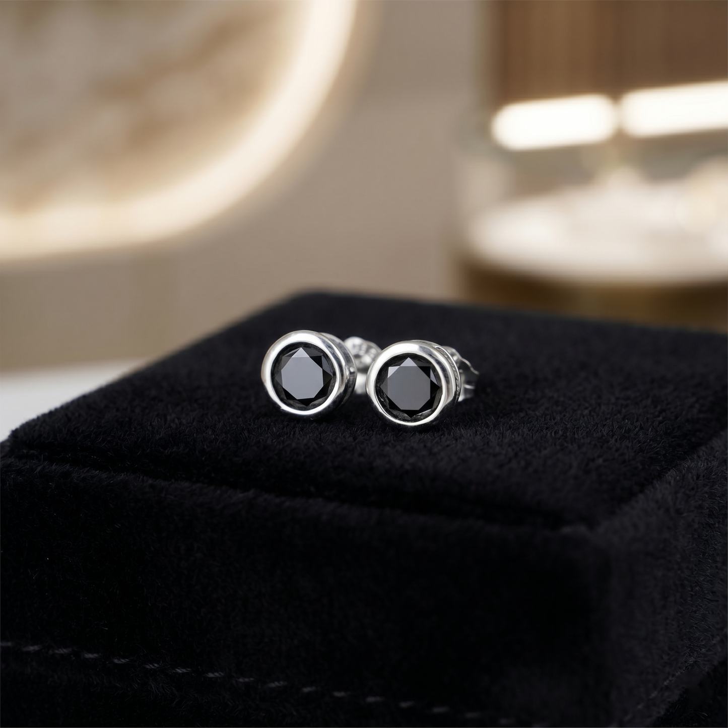 Black bezel solitaire stud earrings, round dark stone with circular silver-tone bezel