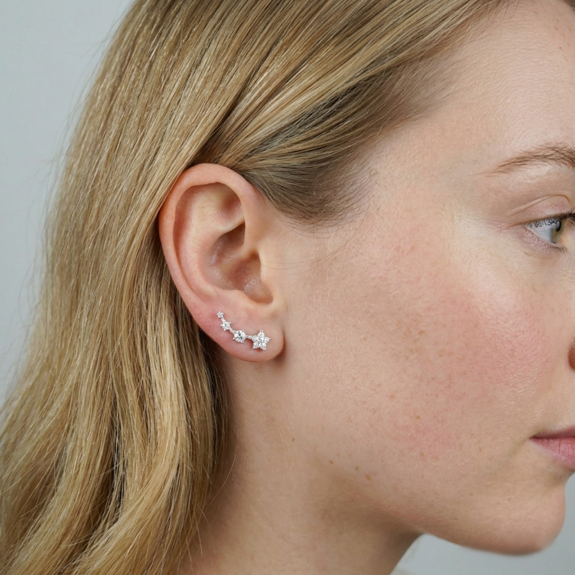 Star CZ ear climbers on model ear, linked mini stars along the ear