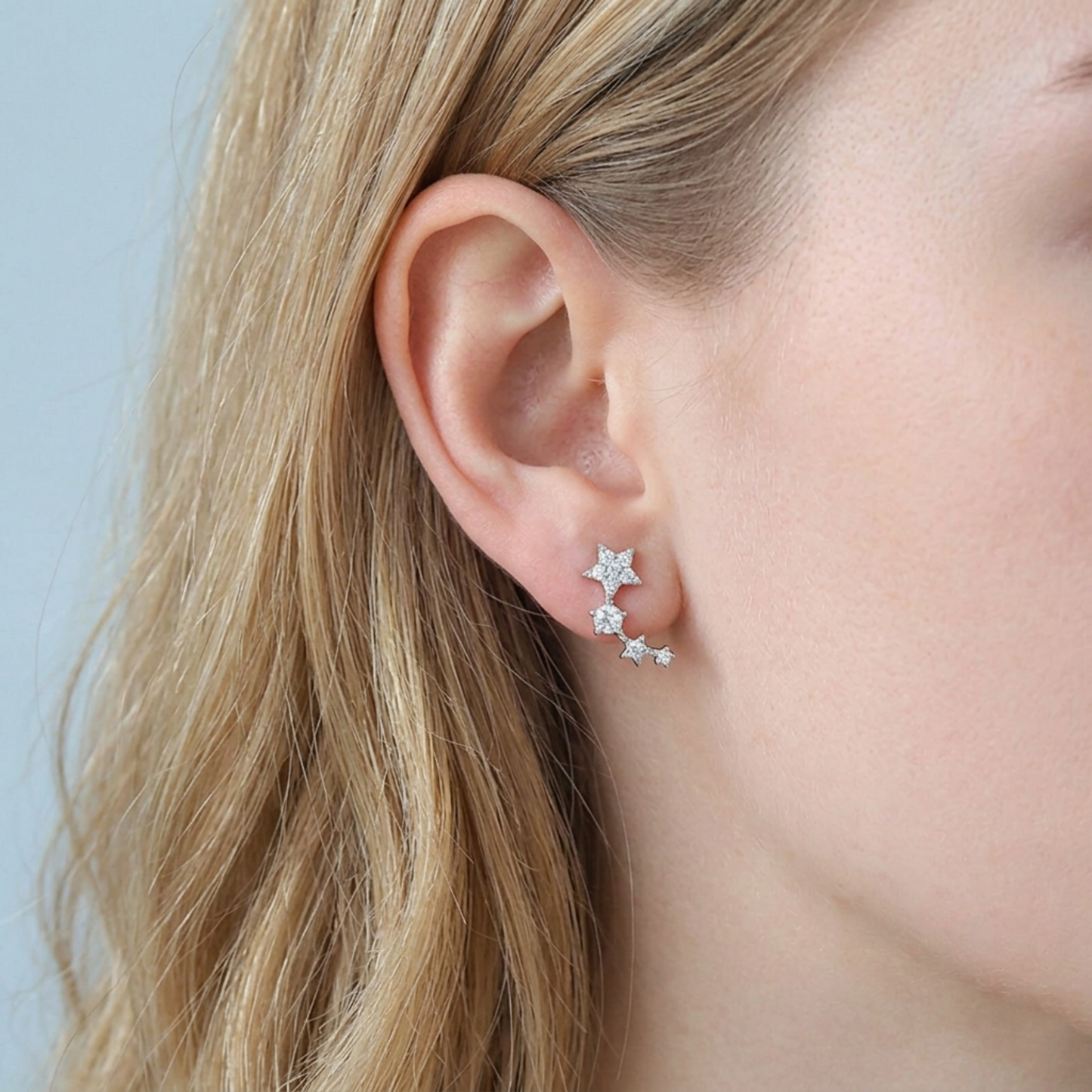 Star CZ ear climbers on model ear, linked star stones along the curve