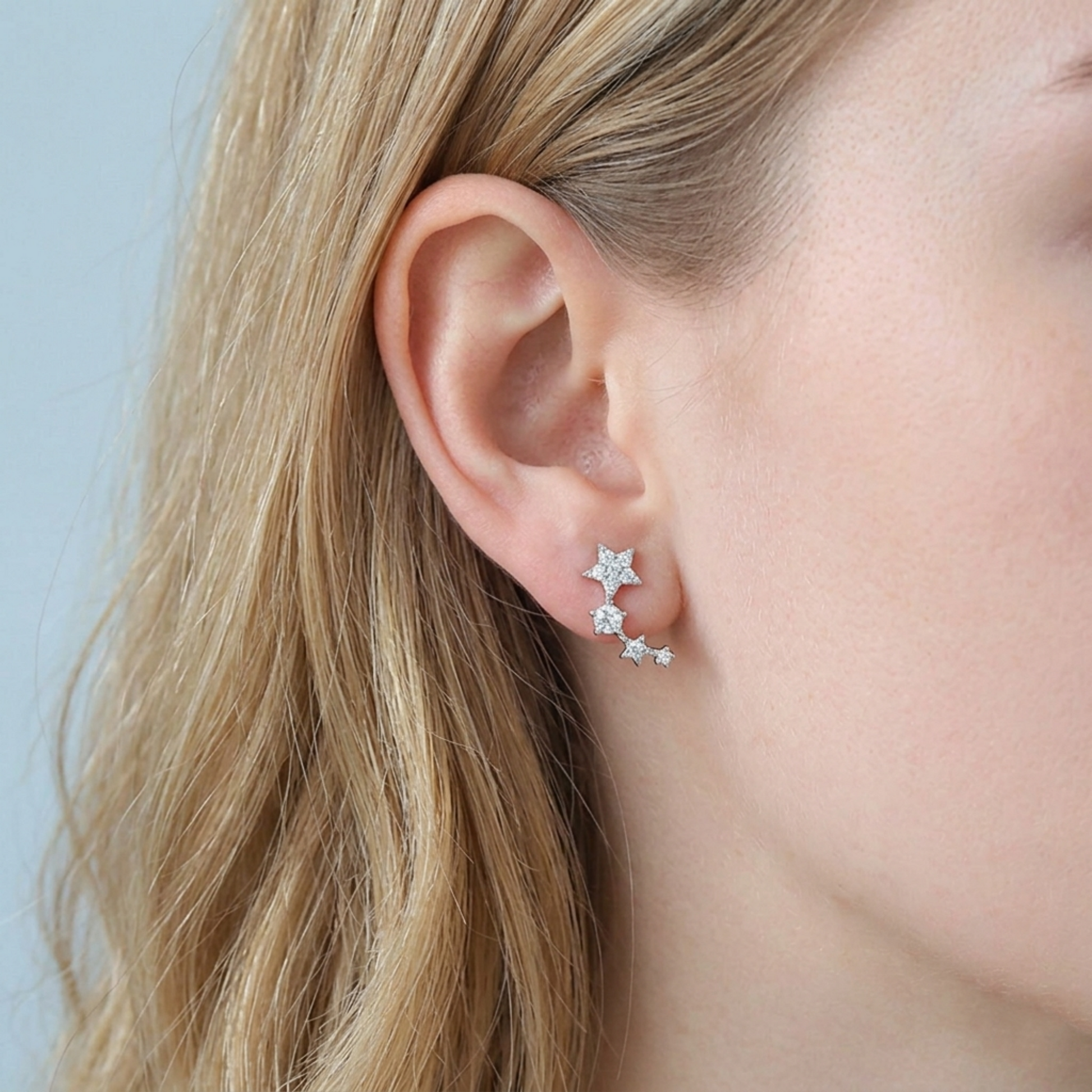 Star CZ ear climbers on model ear, linked star stones along the curve
