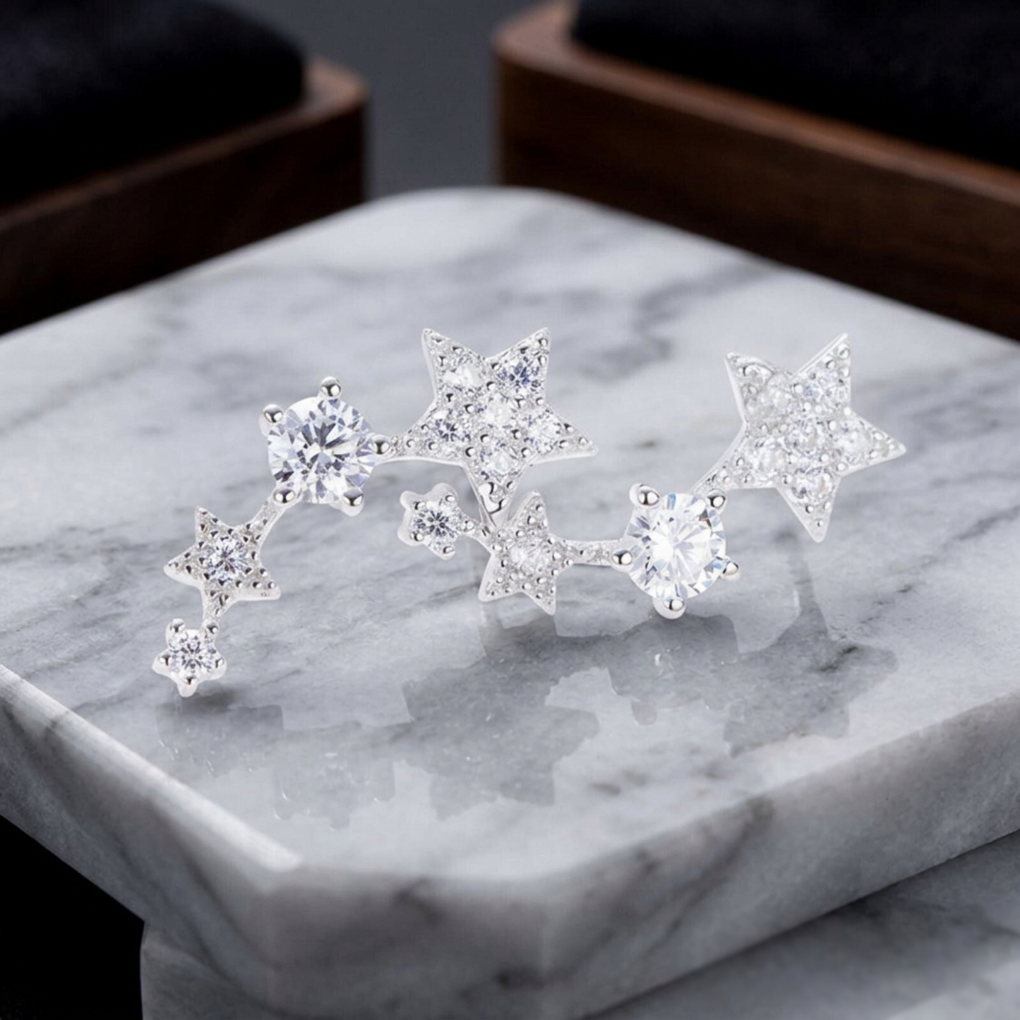 Silver star CZ ear climbers on display, multiple linked stars with crystal stones