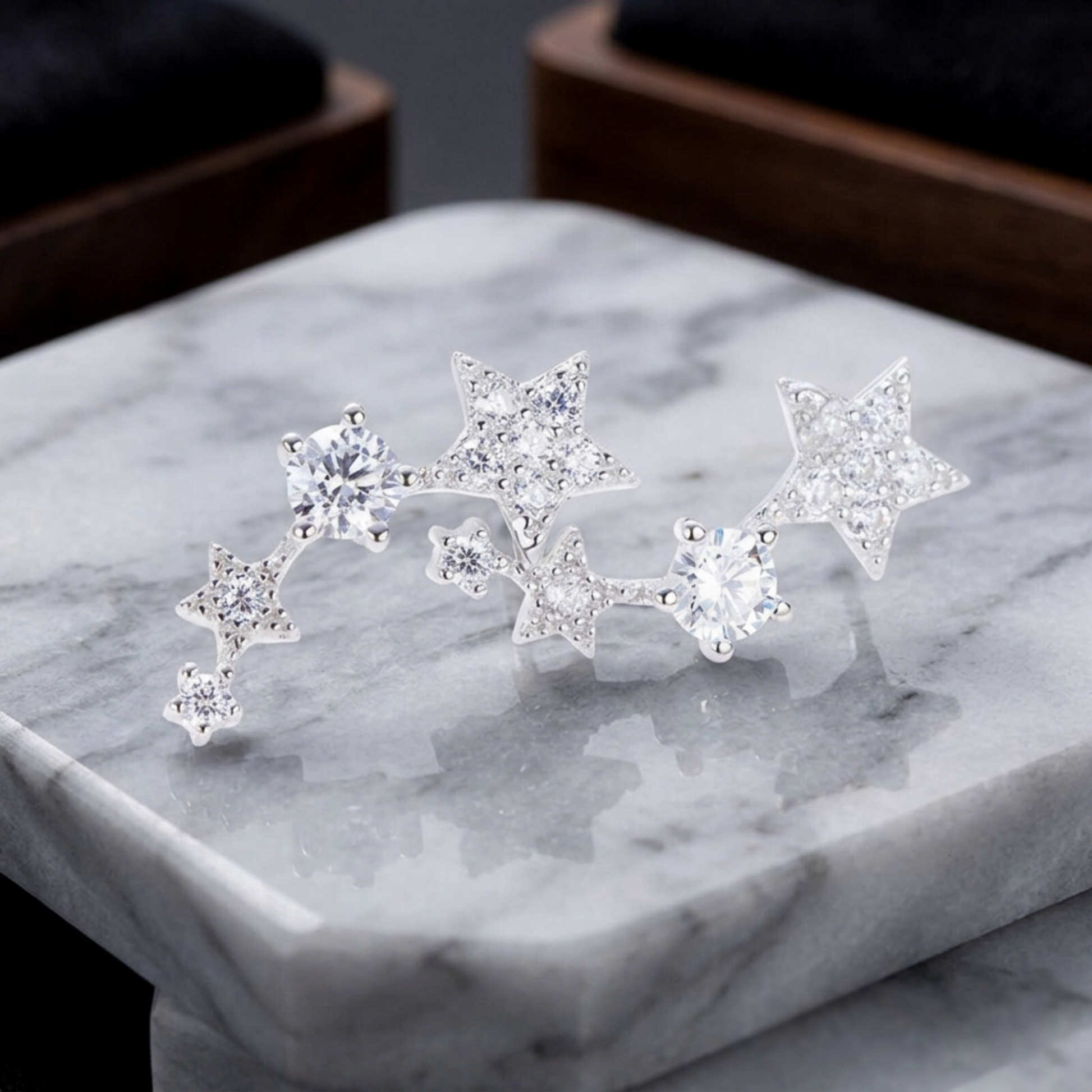 Silver star CZ ear climbers on display, multiple linked stars with crystal stones