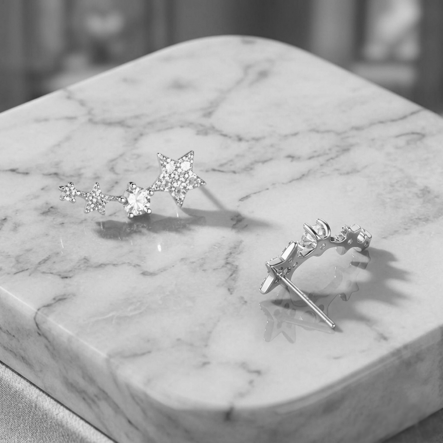 CZ star ear climbers on marble display, linked stars with clustered stones