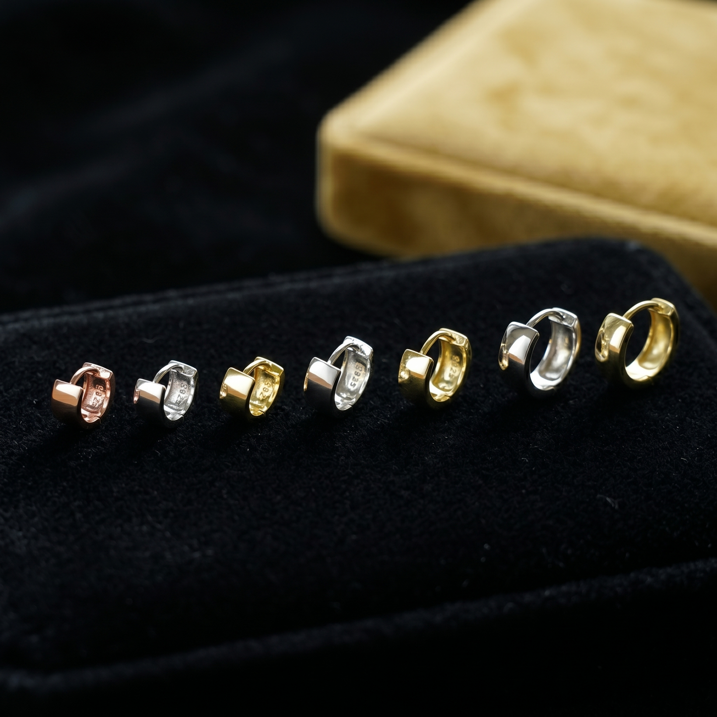 Lineup of 4.5mm sterling hoop earrings in mixed finishes: rose, silver, gold
