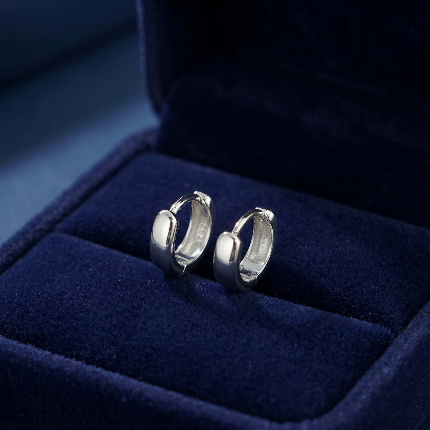 Rhodium-plated sleeper huggie earrings, hoop profile view