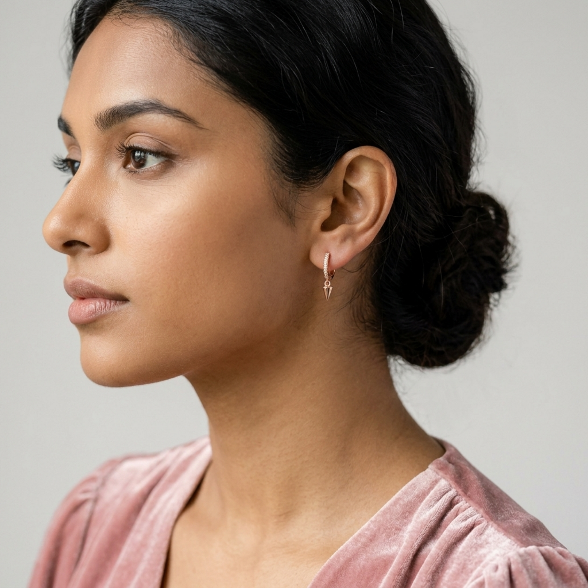 Rose gold cone-spike hoop earrings with dangling pointed charm