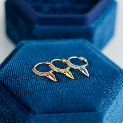 Cone-spike hoop earrings in mixed metals, each with a small pointed charm