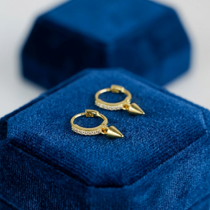 Gold cone-spike hoop earrings with pavé sparkle and small pointed charms