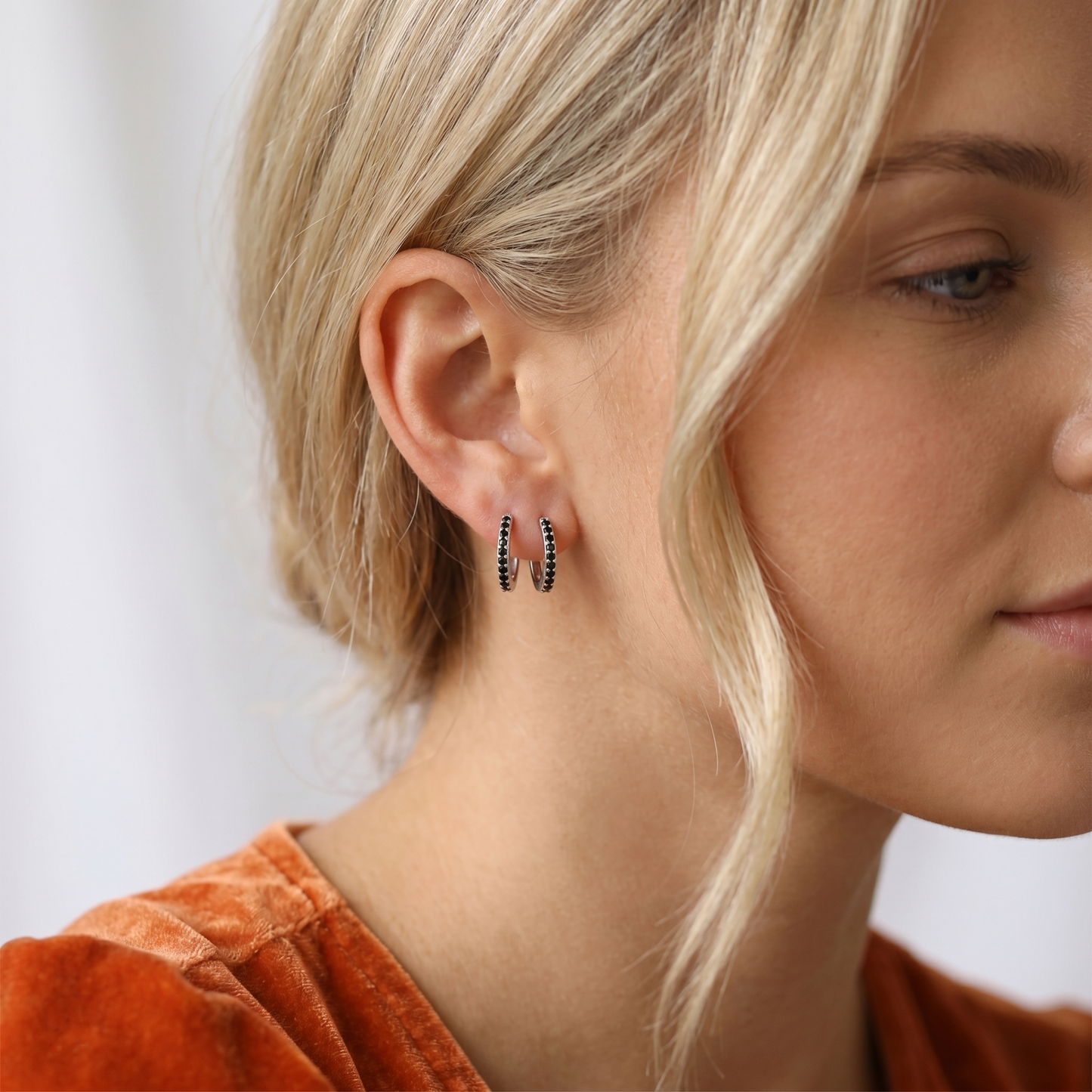Black Contrast Huggie Hoops with dark stone detailing, on small hoop form