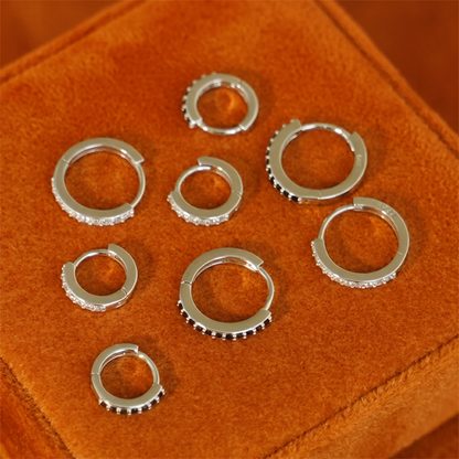 Assorted huggie hoops in silver-tone with clear stone and dark bead trim