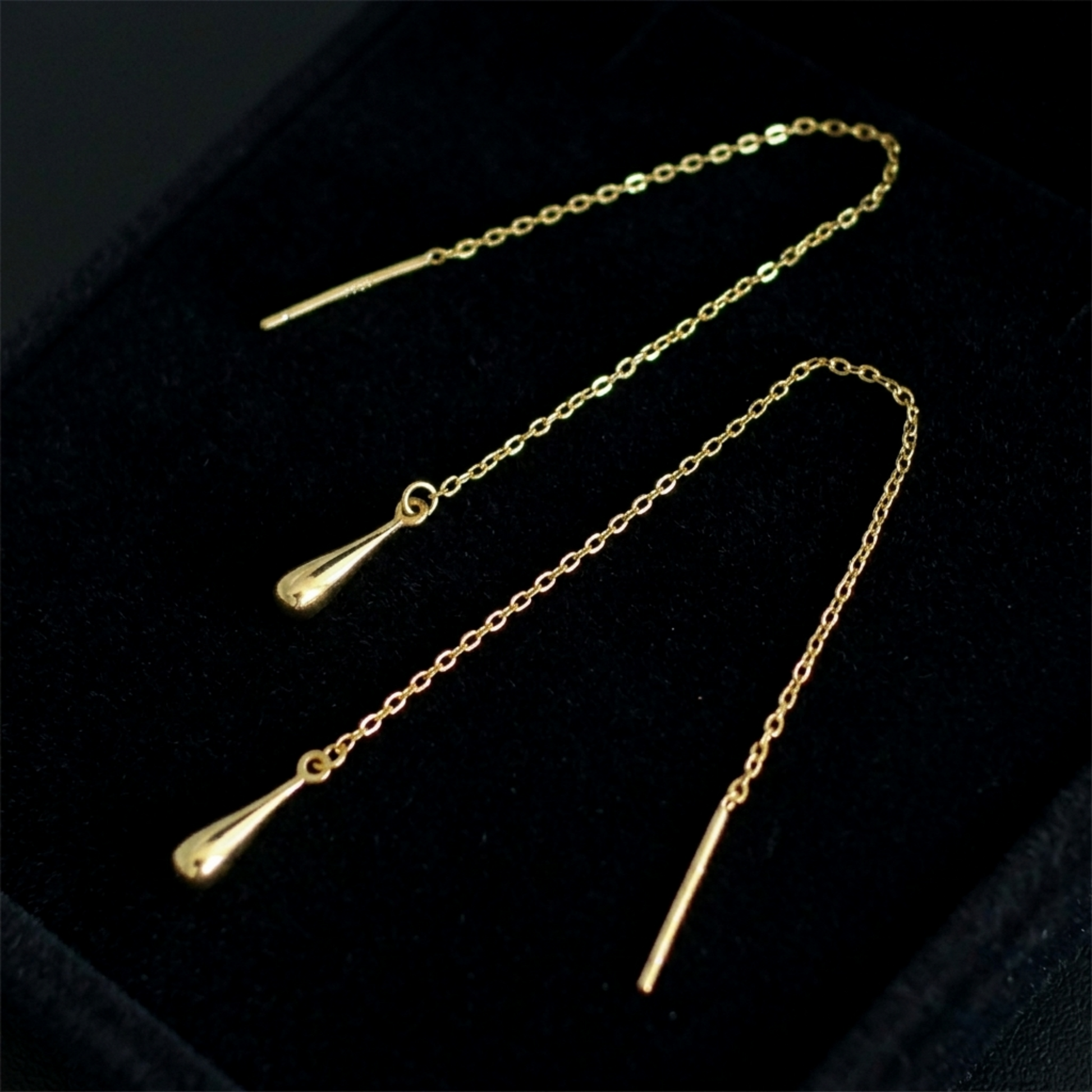 Gold-tone teardrop threader earrings with teardrop drops and long chain in box