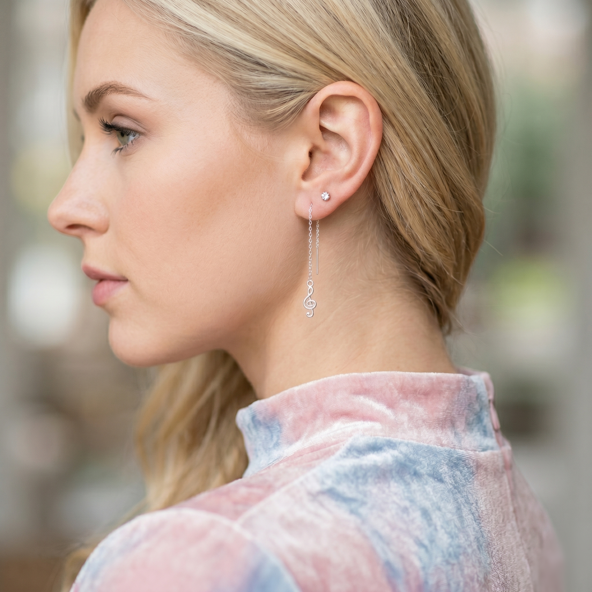 Silver dangling treble-note threader earrings with small top stud at the ear