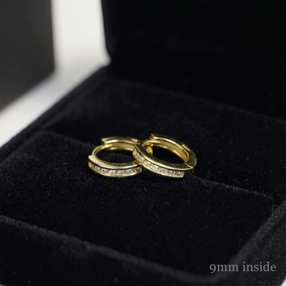 Gold tone Channel Huggie hoops with inset stones, stacked angle on display