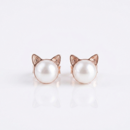 Cat pearl stud earrings with rose gold-tone cat ear frames and small diamond-like details