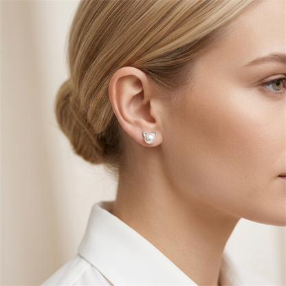 Silver cat pearl stud earrings on model ear, round white pearl with cat-ear top