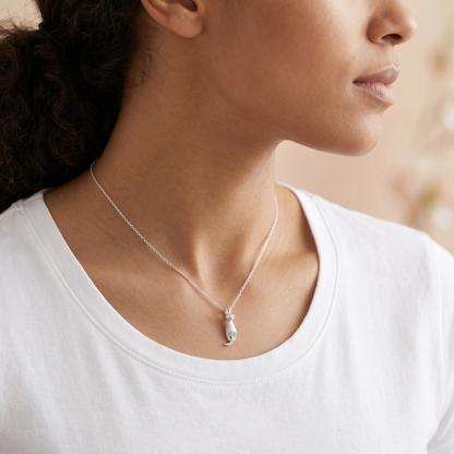 Cat pendant necklace worn on neck, silver chain with curled-tail cat charm