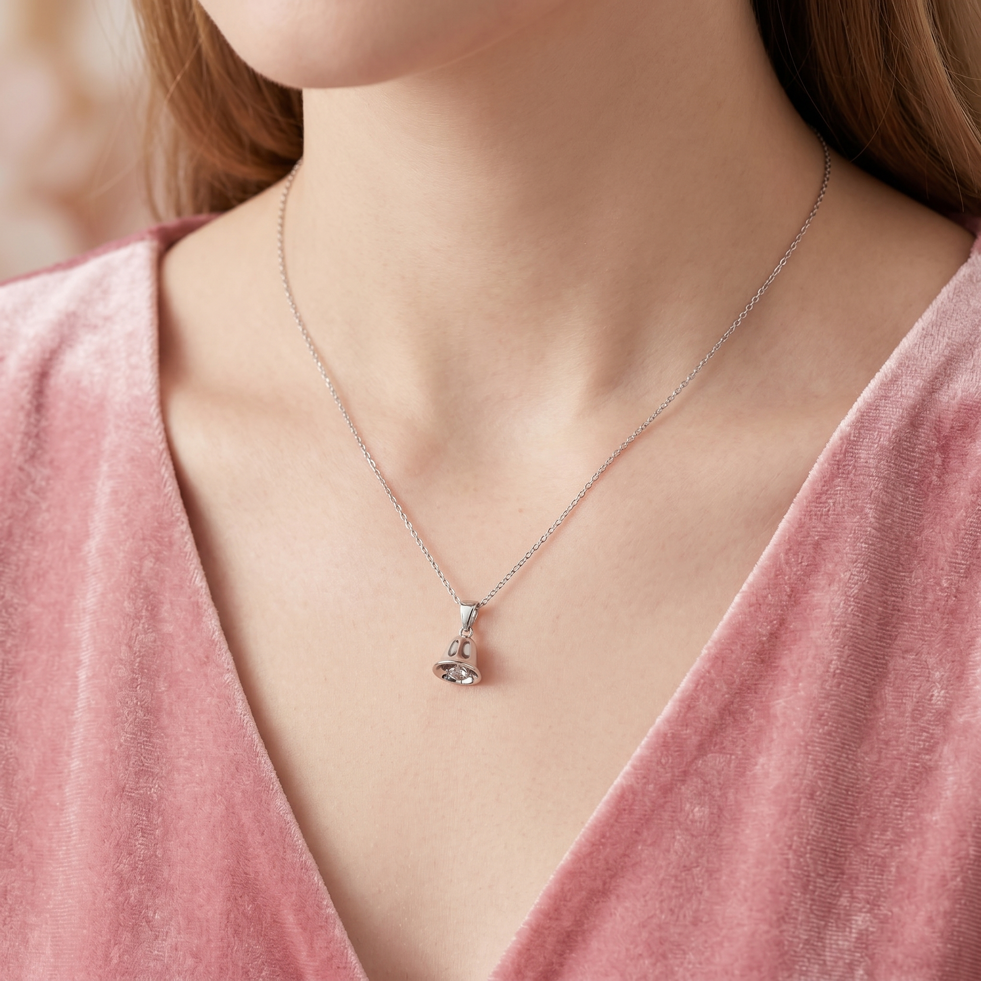 Jingle bell pendant necklace on model, glossy silver bell charm with loop bail