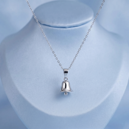 Jingle bell pendant necklace on bust, silver bell charm centered on link chain