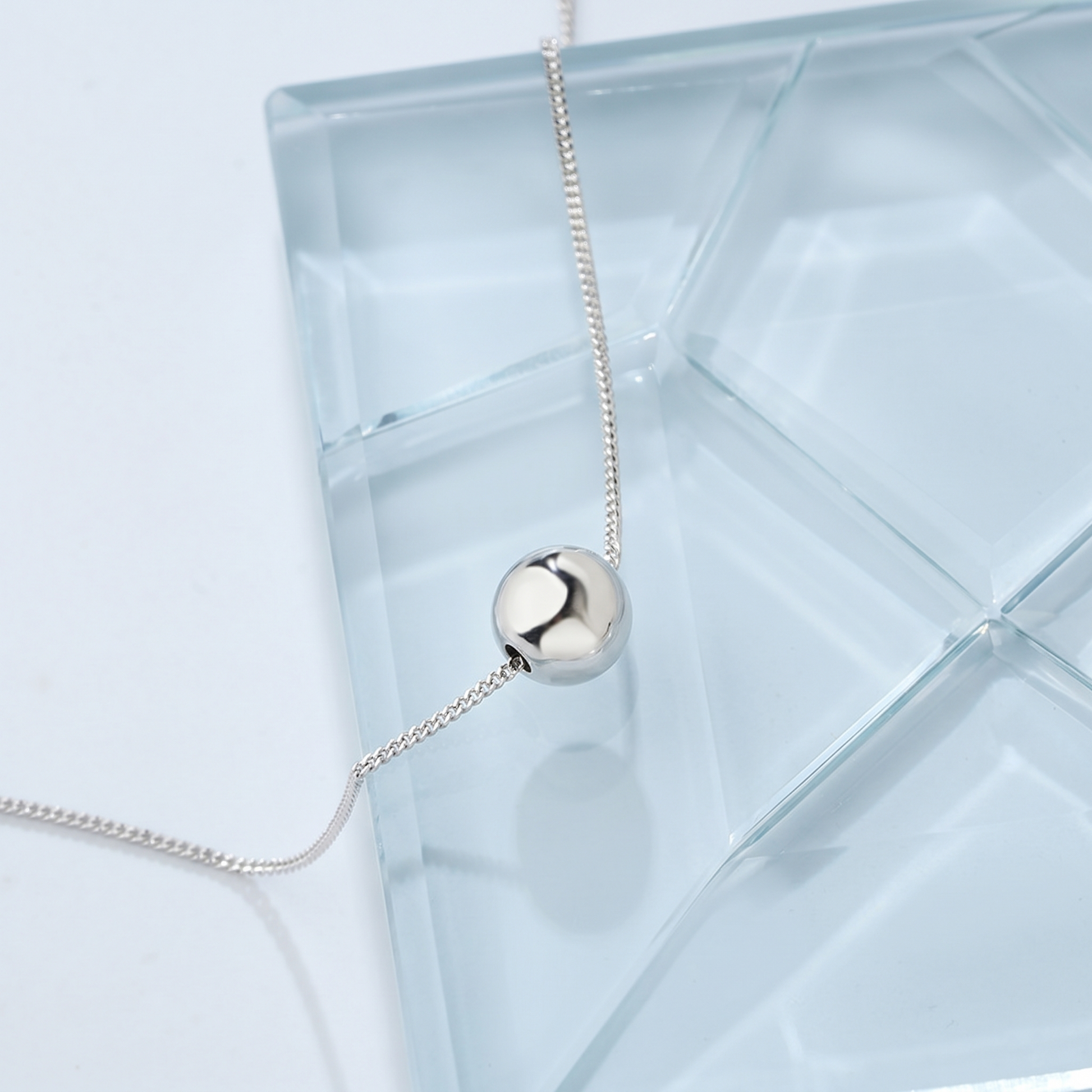 Polished Ball Necklace silver-tone ball pendant with fine chain, side view