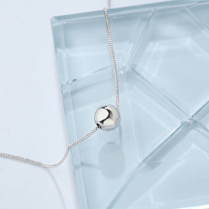 Polished Ball Necklace silver-tone ball pendant with fine chain, side view