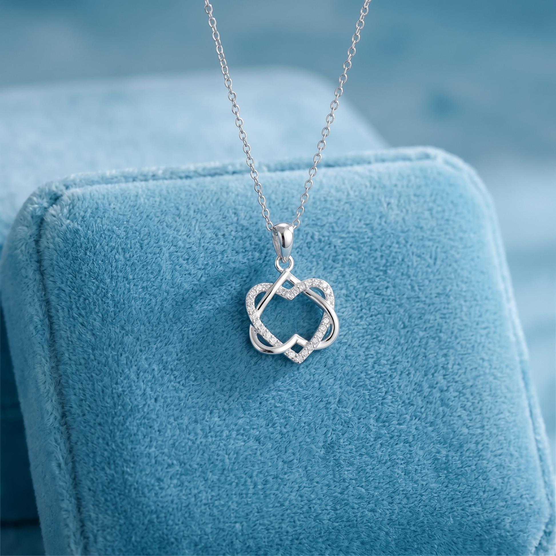Silver heart knot pendant necklace with stone center detail