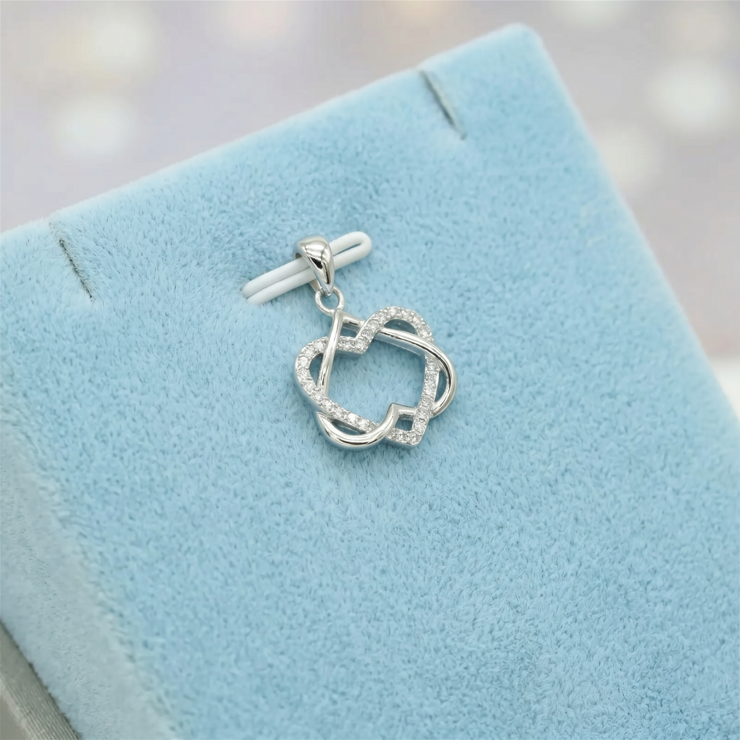 Silver heart knot pendant necklace with linked heart design