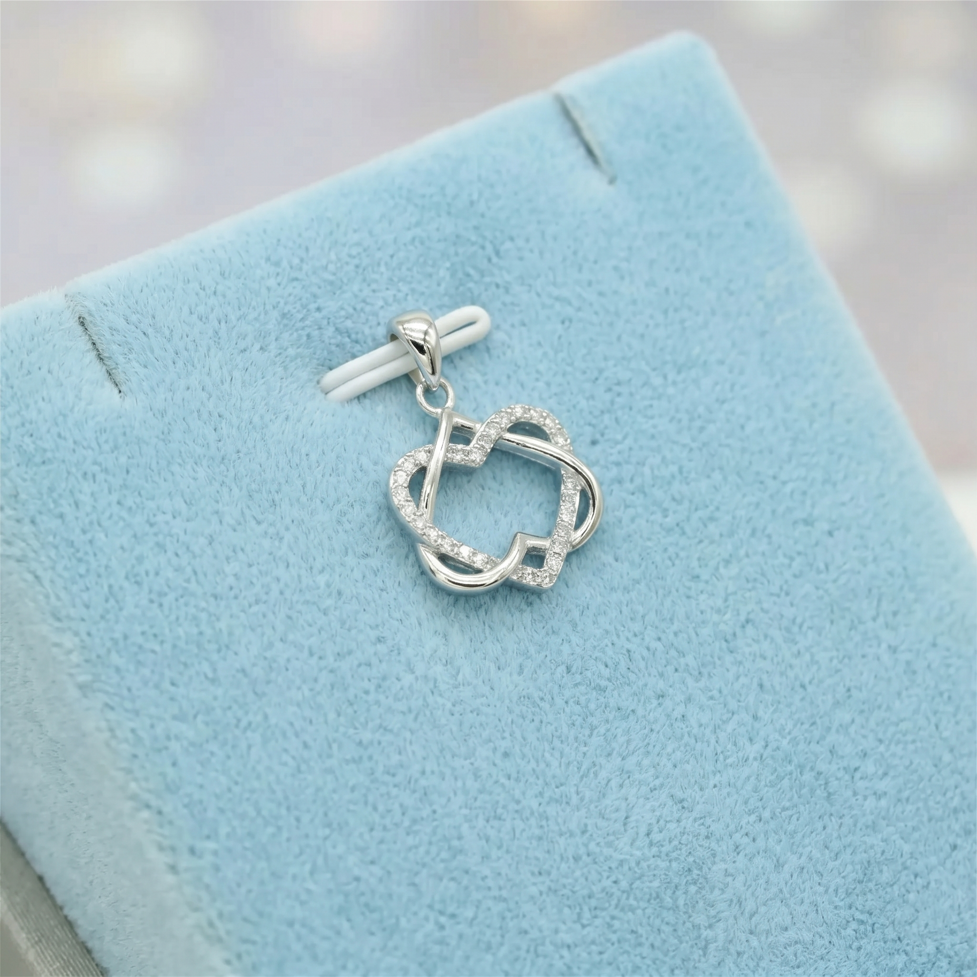 Silver heart knot pendant necklace with linked heart design