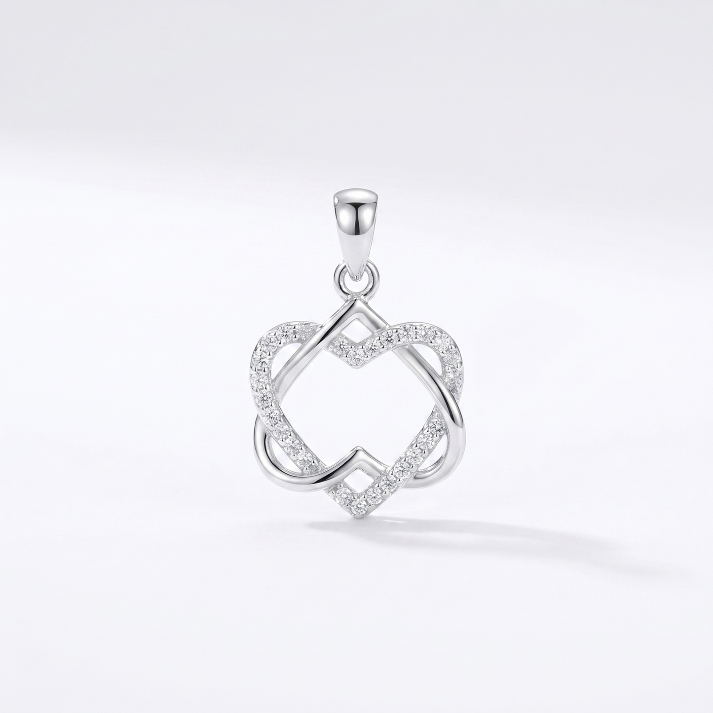 Silver heart knot pendant necklace with clear stone-like accents