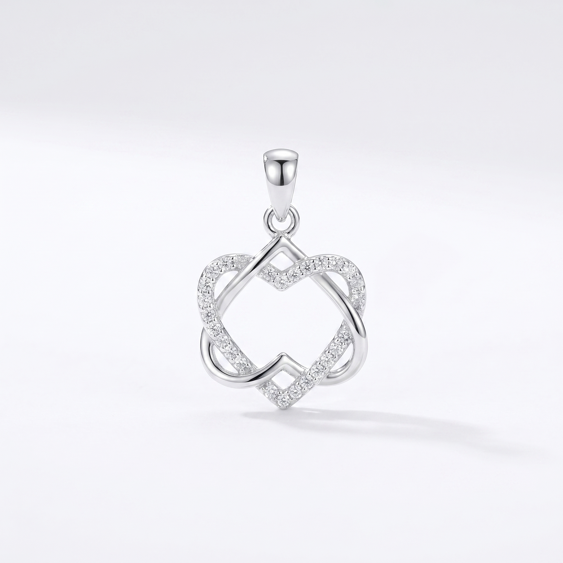Silver heart knot pendant necklace with clear stone-like accents