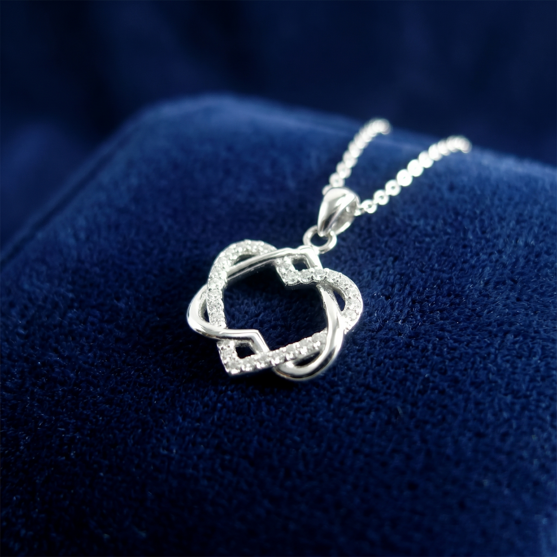 Silver heart knot pendant necklace close-up on a chain
