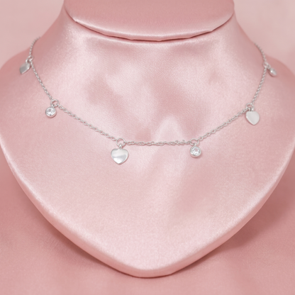 Silver-tone choker with three heart charms and two small round CZ charms