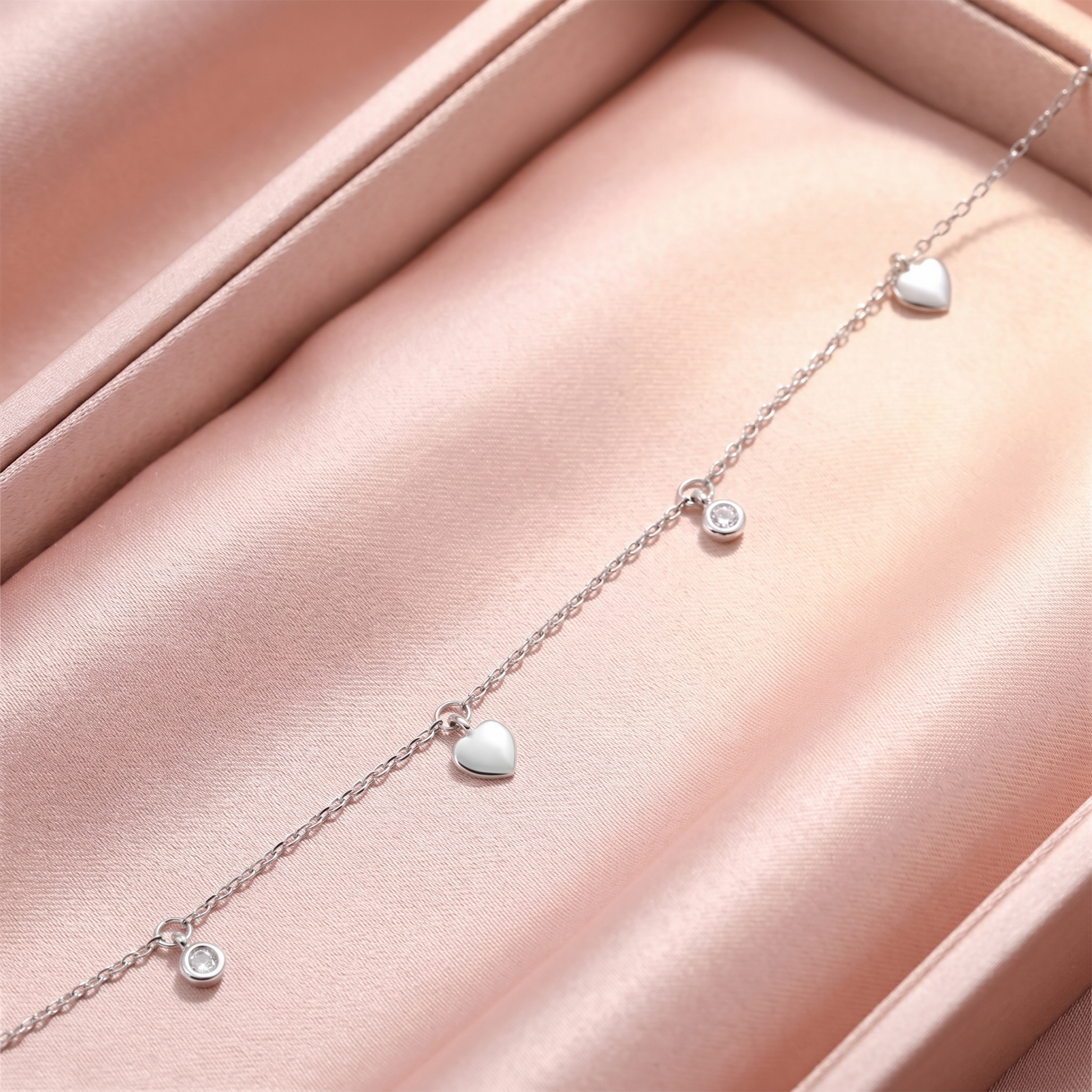 Silver-tone choker with heart and round CZ charms on a delicate chain