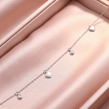Silver-tone choker with heart and round CZ charms on a delicate chain