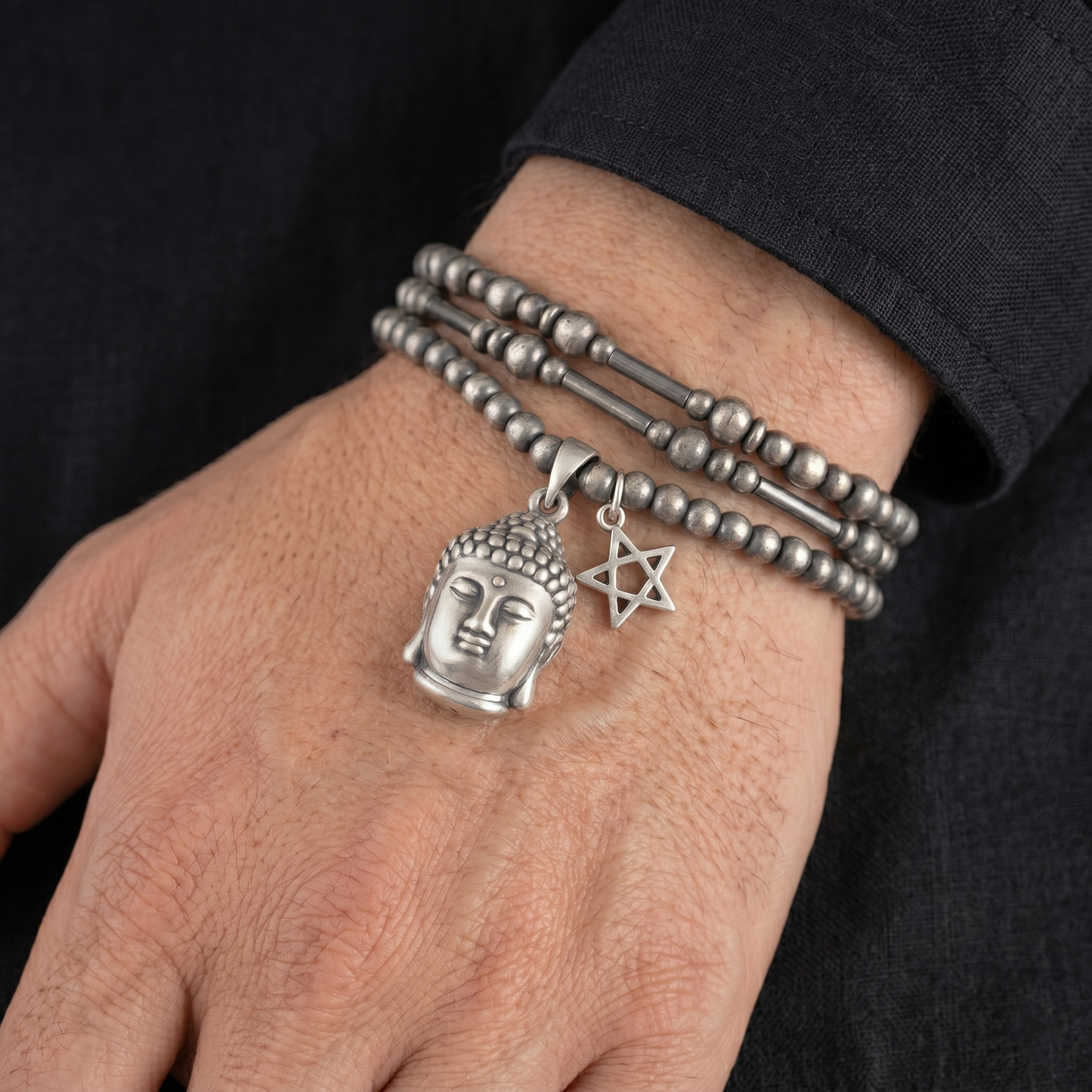Buddha head charm pendant on beaded bracelet with other charms, silver-tone